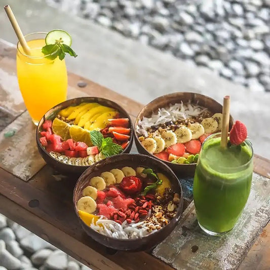 coconut bowls with wooden spoons -- Coconut shell bowls, suitable for serving yogurt, salad, or ice cream.