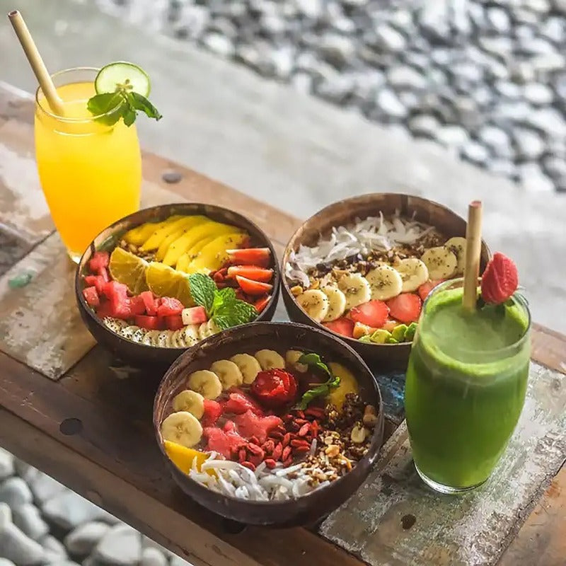 coconut bowls with wooden spoons -- Coconut shell bowls, suitable for serving yogurt, salad, or ice cream.