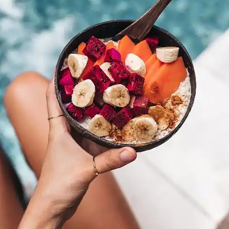 coconut bowls with wooden spoons -- Coconut shell bowls, suitable for serving yogurt, salad, or ice cream.