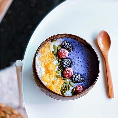 coconut bowls with wooden spoons -- Coconut shell bowls, suitable for serving yogurt, salad, or ice cream.