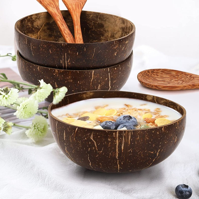 coconut bowls with wooden spoons -- Coconut shell bowls, suitable for serving yogurt, salad, or ice cream.